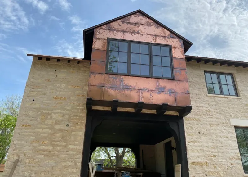Copper metal panel facade on a stone building for Skylight Installation in Sylvania